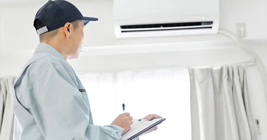 A man inspecting air quality from an air conditioner