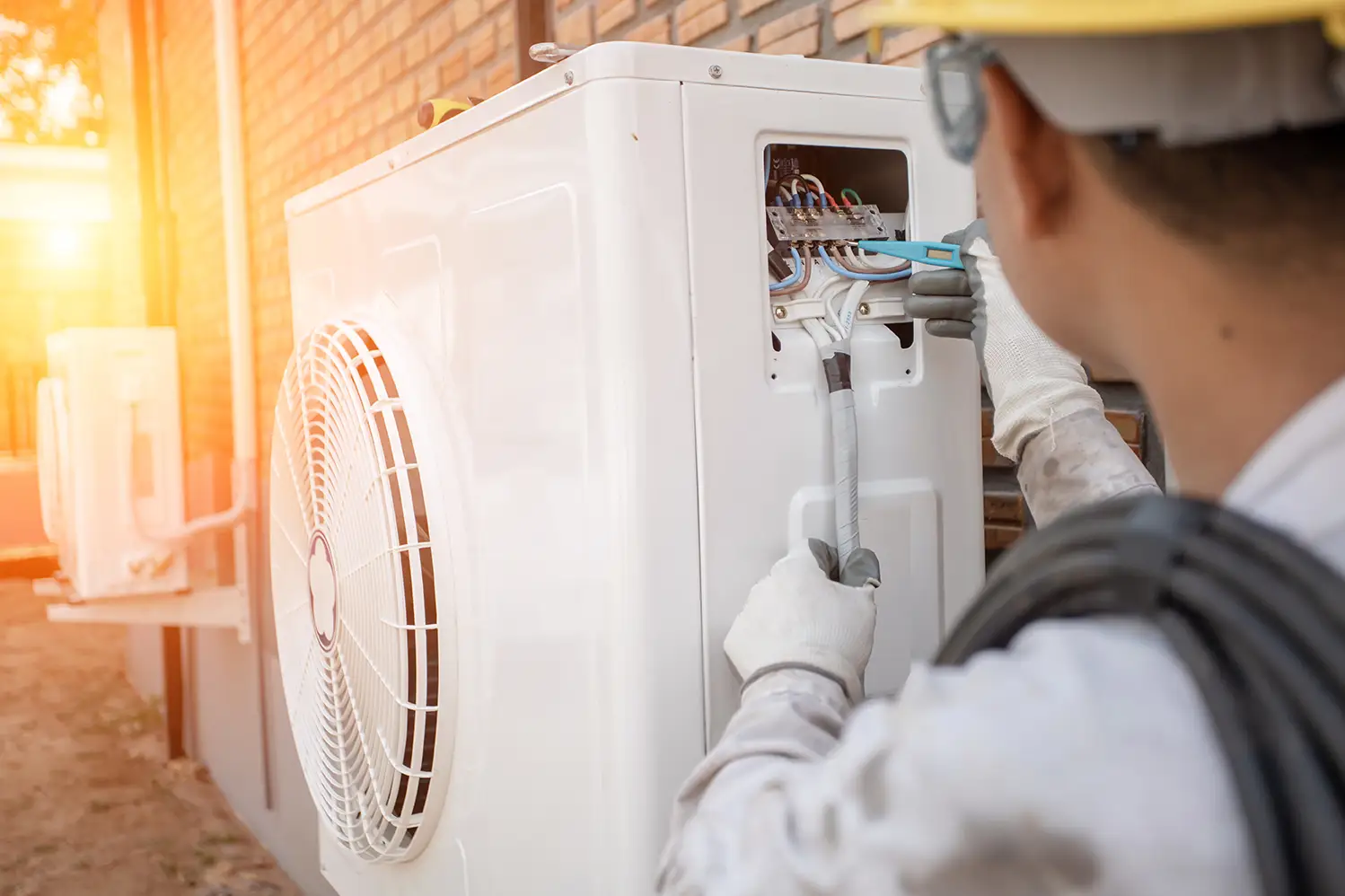 A man installing an air conditioner
