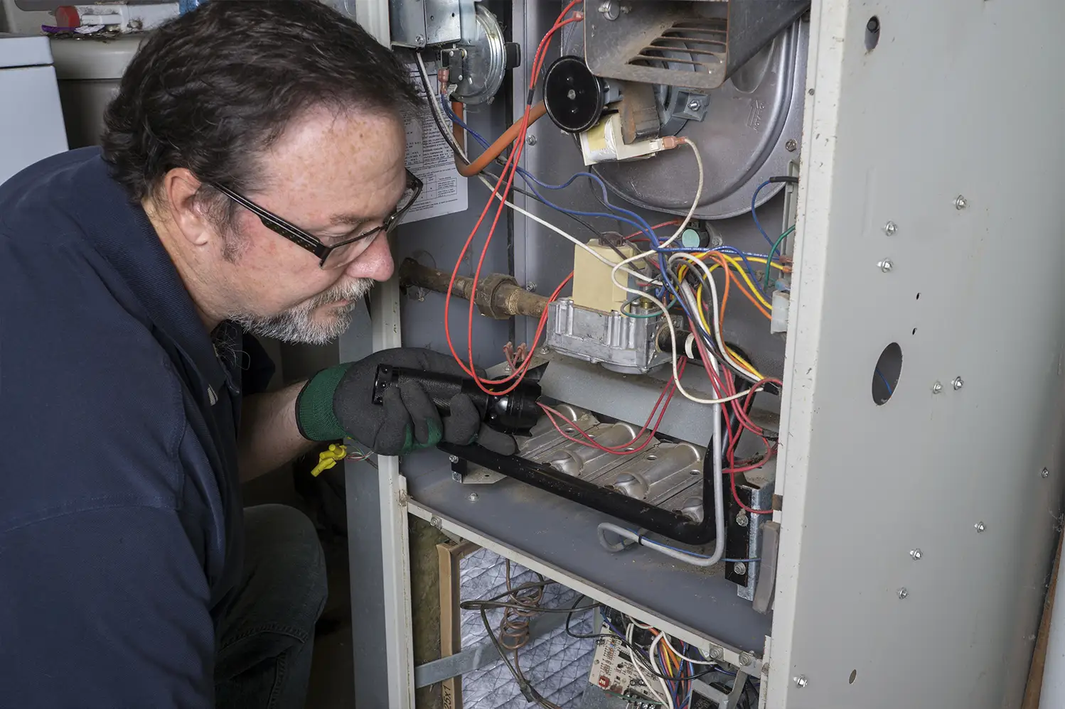A man installing a furnace