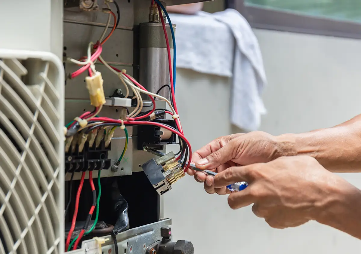 A man repairing an air conditioner